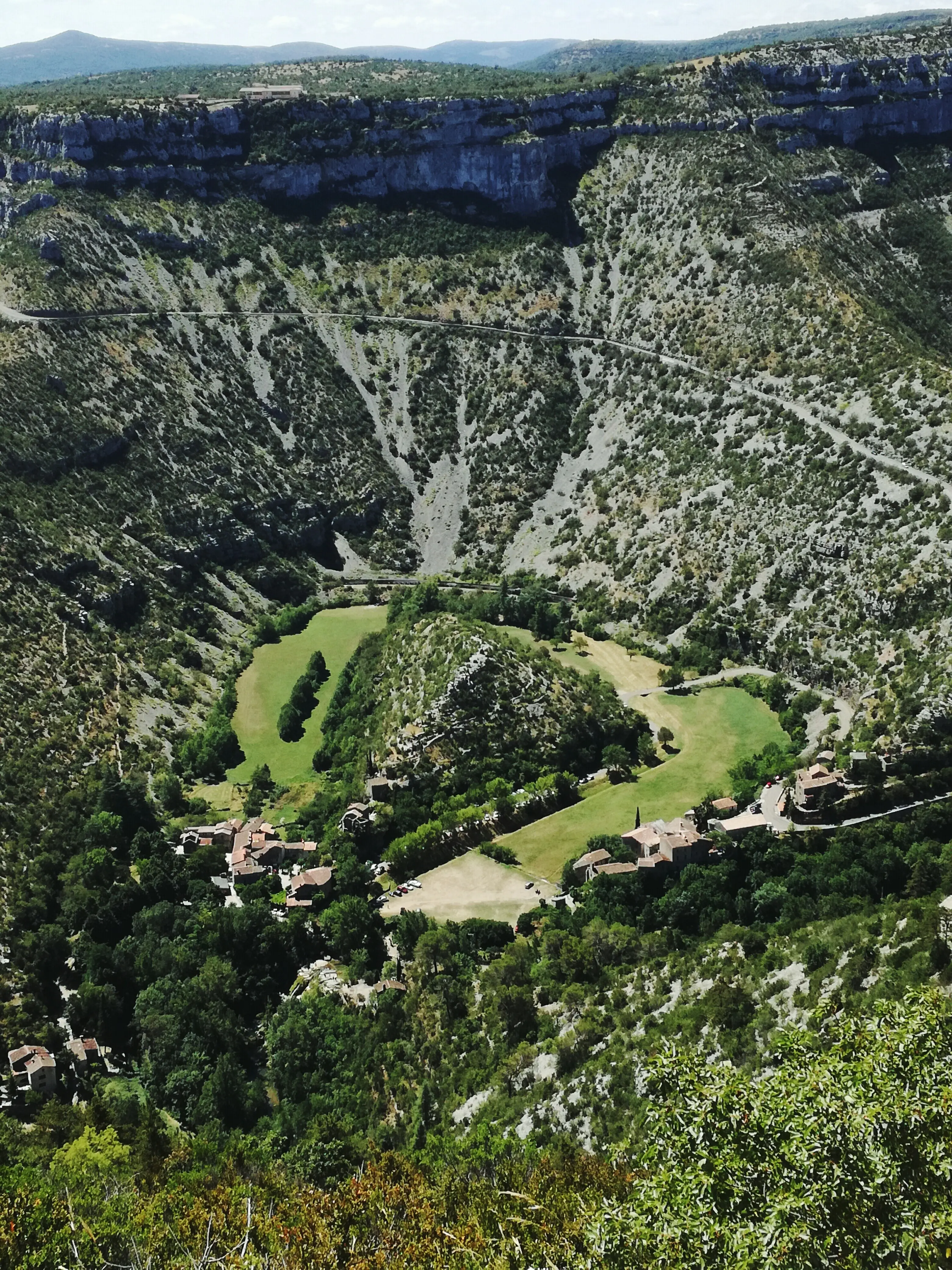 High-angle shot of a calm lake beside rocky terrain