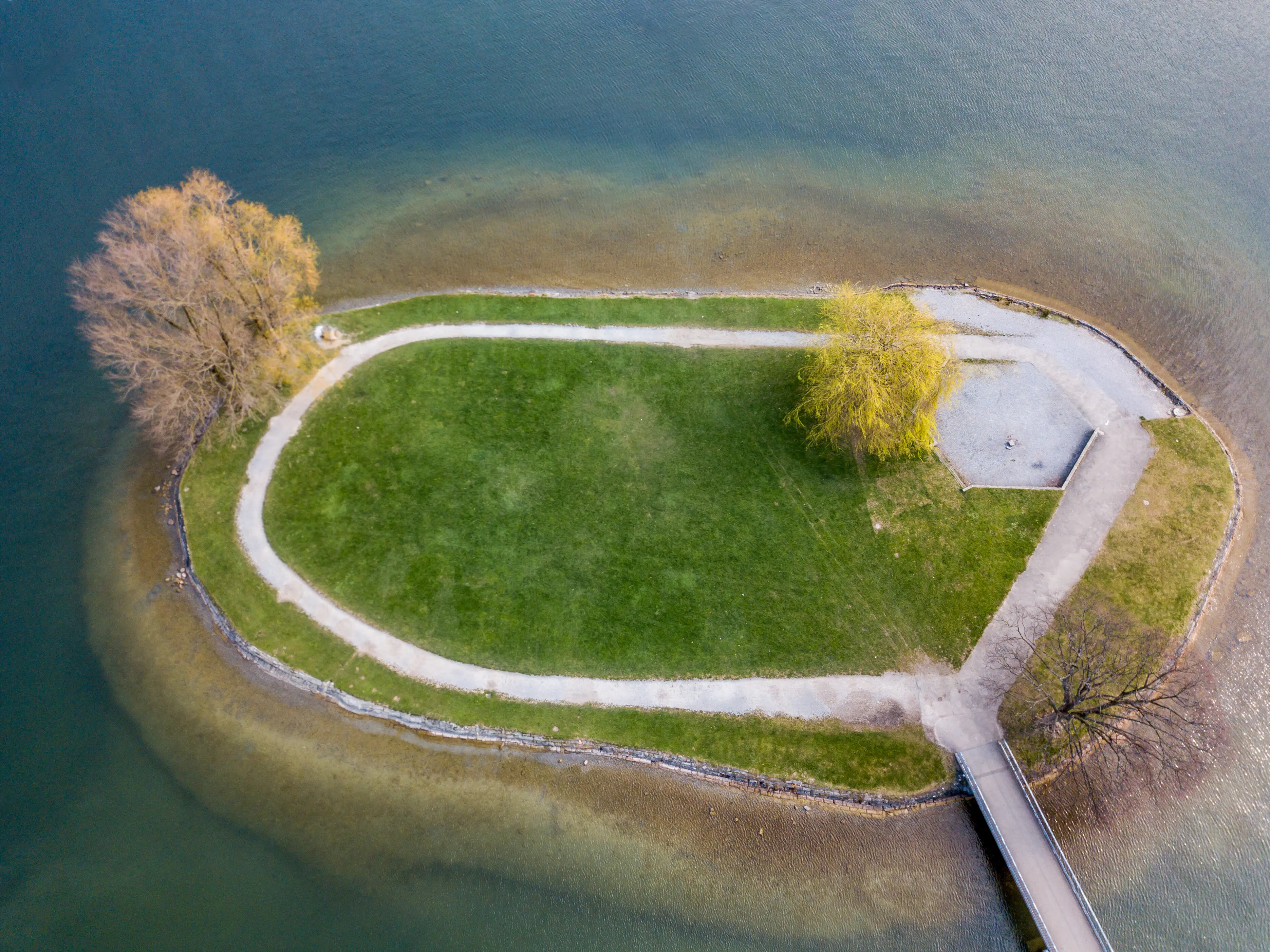 Bird's-eye view of a farm by a lake